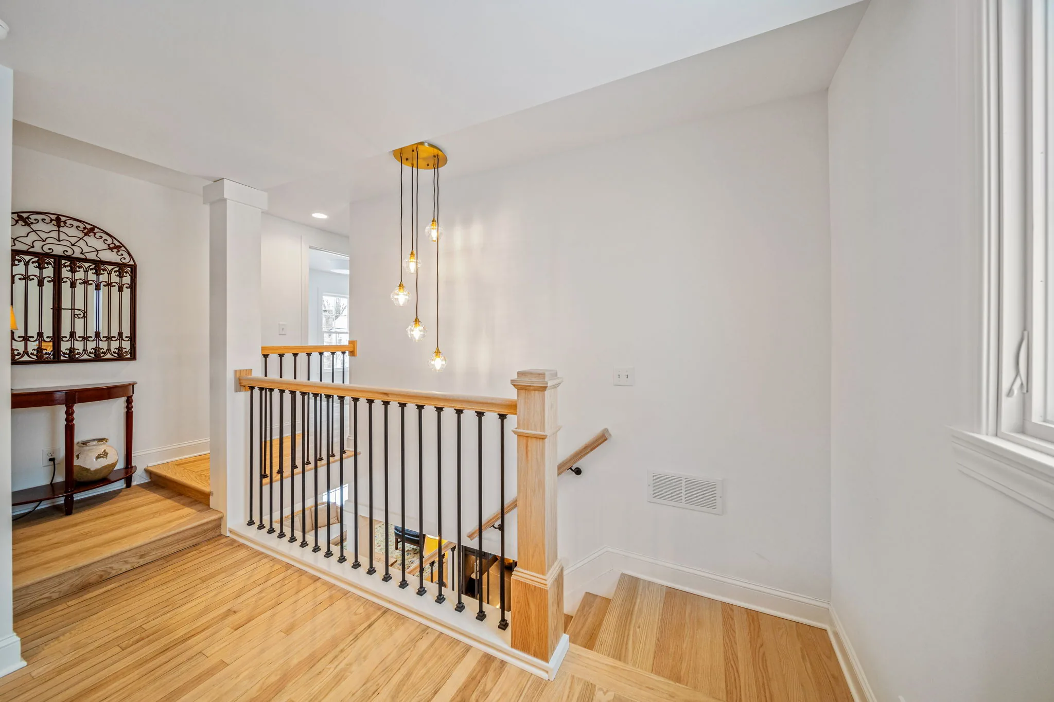 Second-floor landing with iron balusters — renovation detail work